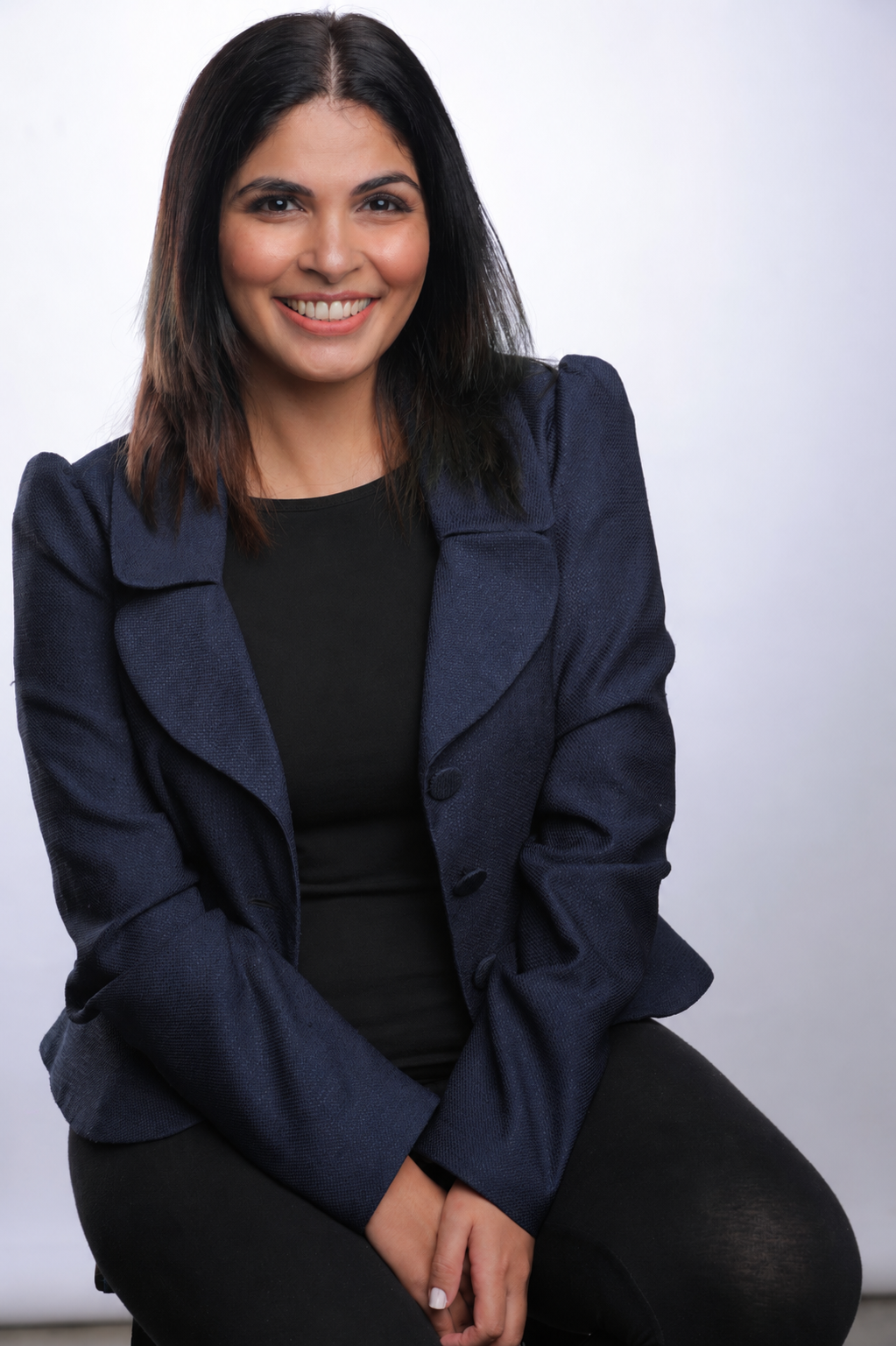 Seema Parwani, founder of NextGen Writers India, smiling and holding her dog